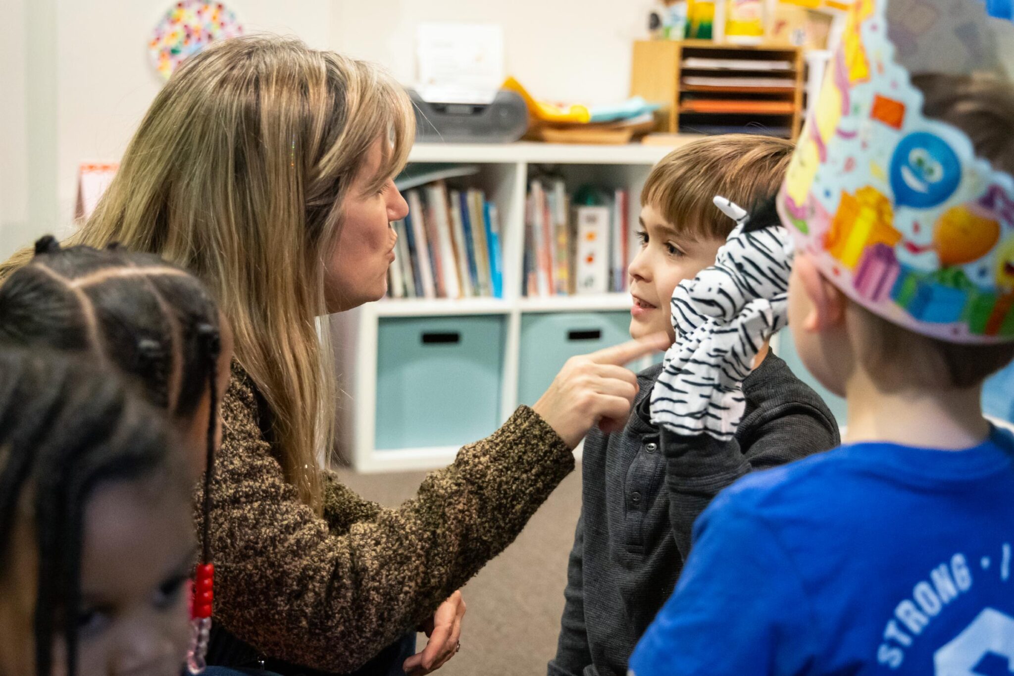 Adult and child playing with hand puppets